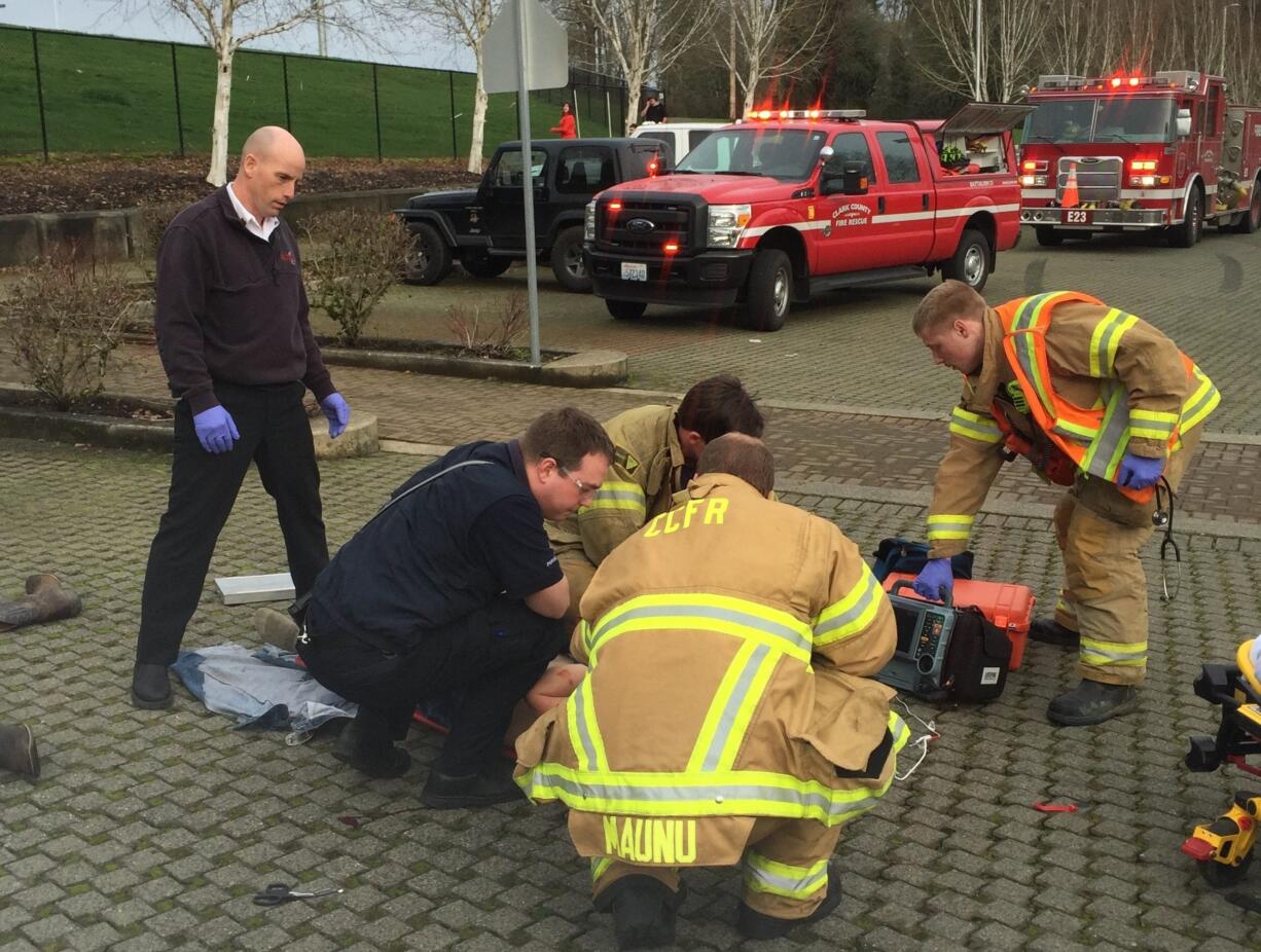 First responders attend to a teenage boy injured Tuesday afternoon after he apparently, according to the La Center Police Department, fell from the hood of a truck.