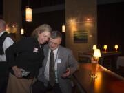 Evergreen School District communications director Gail Spolar offers a hug to Superintendent John Deeder after election results were posted Tuesday night. Supporters gathered at Vinotopia in east Vancouver to celebrate the passage of a three-year school levy.