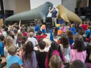 Jenni Remillard, education specialist with the Oregon Coast Aquarium, with life-size inflatable elephant seal Nigel, left, and seal lion Stanley, right, gives a presentation at Dorothy Fox Elementary School on Wednesday.