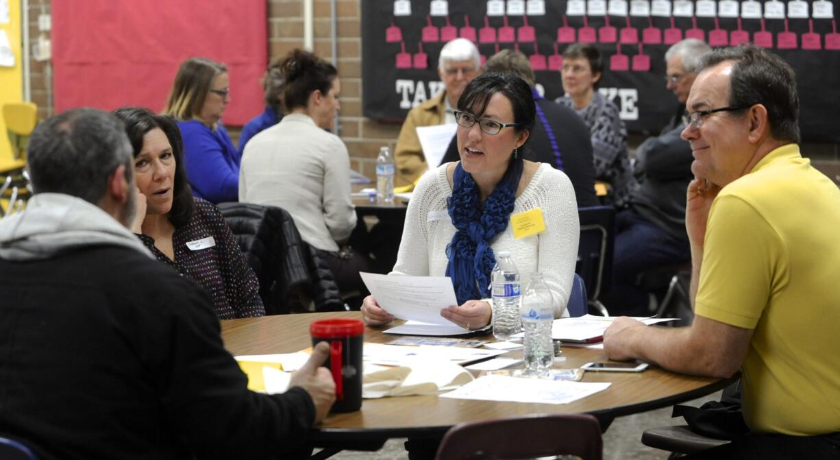 Stephanie McClintock, center, talks with other members at the GOP precinct caucus at Prairie High School on Saturday. McClintock said she hopes to see local Republicans work together this year to uphold conservative principles.