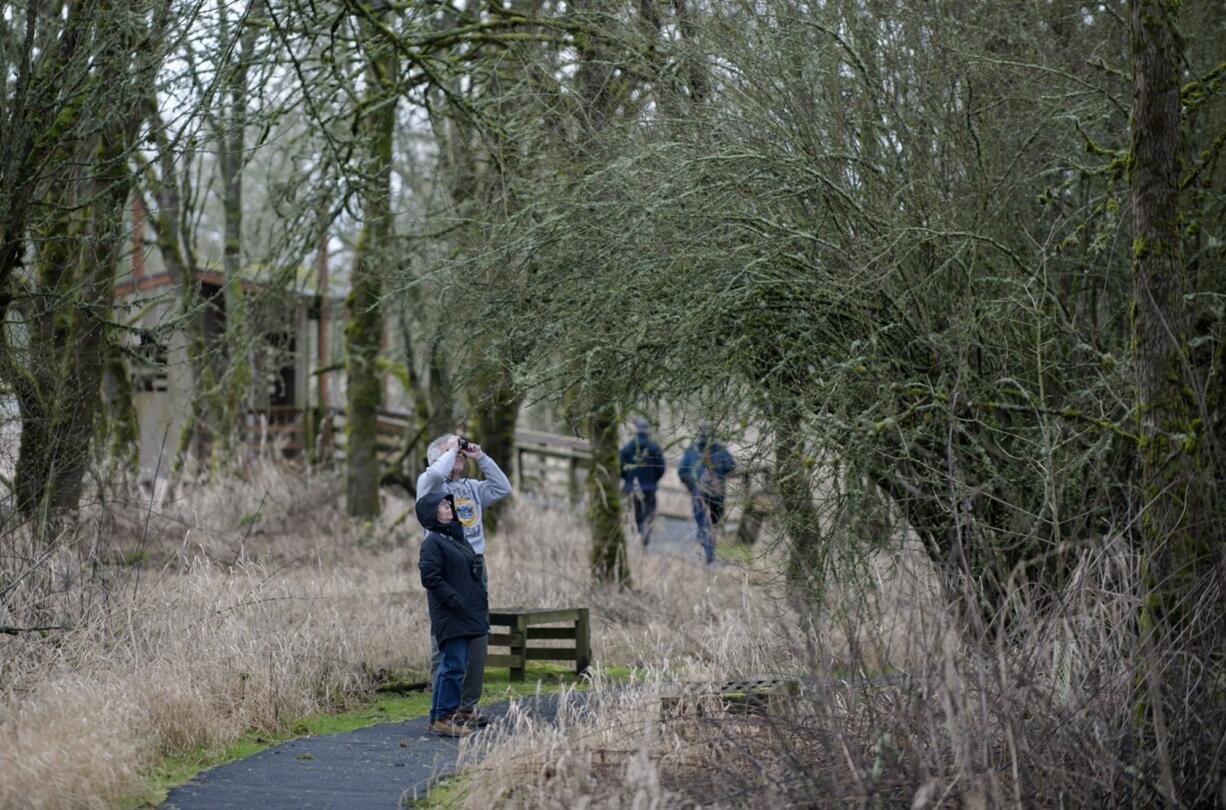 Karlene and Scott Lusby of Portland search for different species of birds and other wildlife with binoculars Monday afternoon at the Ridgefield National Wildlife Refuge. Officials closed part of the refuge and canceled a bird hunt last week due to safety concerns connected to the ongoing standoff between armed protestors and law enforcement in Southeast Oregon. The Ridgefield refuge has since re-opened, and the regular waterfowl hunting schedule has resumed, according to the refuge.