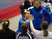 Ridgefield's Kylee Tjensvold receives congratulations after her routiine on the bars during the 1A/2A/3A State Gymnastics Finals Saturday, Feb. 20, 2016. Tjensvold  scored 9.125 in the event and took seventh place.