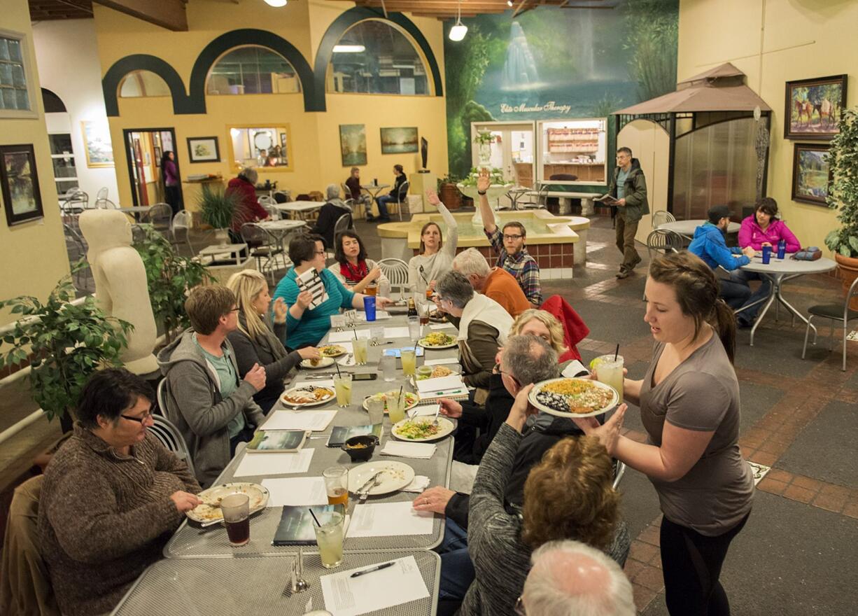 Woody&#039;s Tacos waitress Stephanie Sheldon, right, serves food and margaritas during the First Presbyterian Church theopub on Feb. 4.