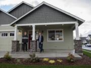 Andrew Olin, 22, of Olin Homes, left, talks with his father, Ivan Olin, 46, as they stand near the front of a model home in Battle Ground that is wheelchair-accessible and designed for aging in place.