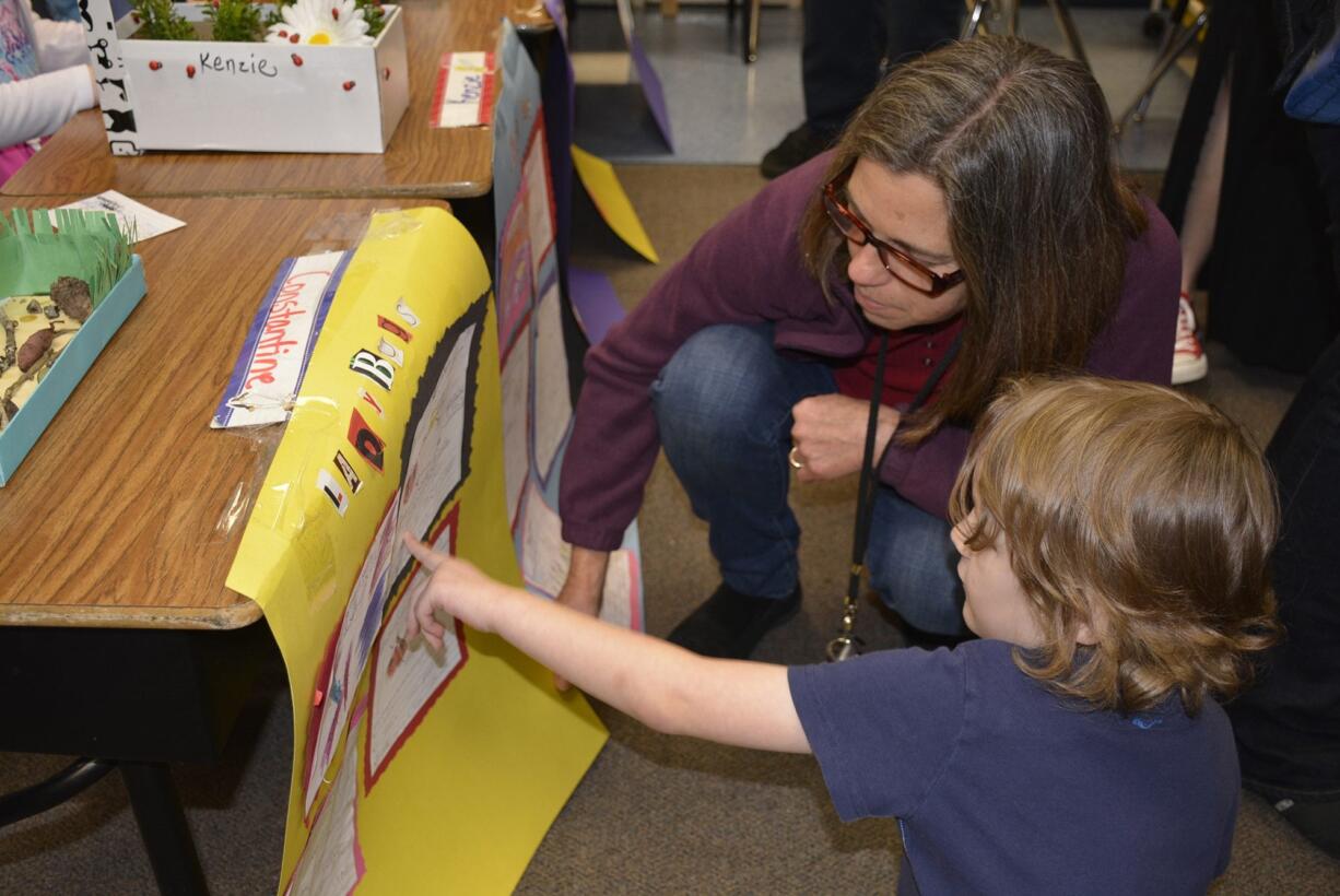 Student Constantine Kuhn shows Kathy Marty his work.