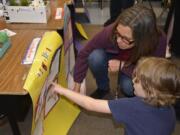 Student Constantine Kuhn shows Kathy Marty his work.