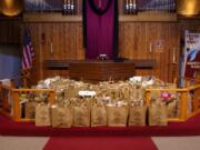 Food collection for the fourth Sunday is placed around the altar as a visible offering.