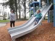 Kystran Knight, 3, slides on a new play structure as her mother, Mariah Watts, watches. Stockford Village Neighborhood Park was updated last month. A bright, new place structure has replaced old monkey bars and a swing set.