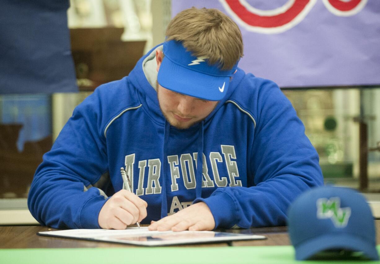 Mountain View&#039;s Chris Mitchell, a football player, signs a contract to play football for the Air Force Academy, during a ceremony at his school in Vancouver Wednesday February 3, 2016.