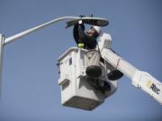 Jerry Plunkett of Lumenal Lighting installs an LED streetlight along Northeast Tanoak Drive, Camas, part of the city&#039;s $3 million project to replace all streetlights with LEDs.