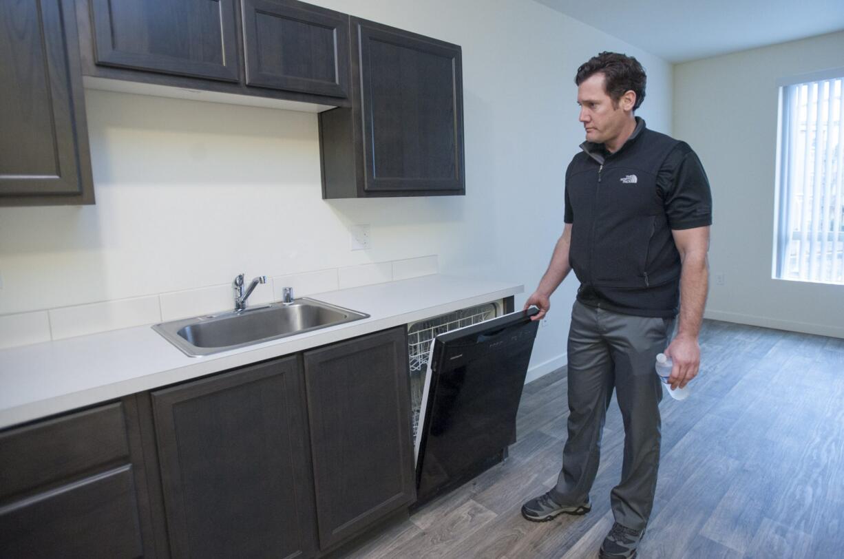 Vancouver Mayor Tim Leavitt checks out a studio apartment at 15 West Apartments, an income-restricted apartment complex that will soon open.