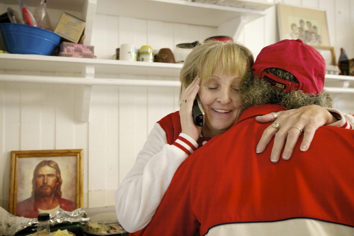 Michele Kruchoski embraces a Martha&#039;s Pantry client on a typical day in 2013. Kruchoski died overnight Wednesday but not before getting to speak to U.S. Sen. Patty Murray at the pantry earlier that day.