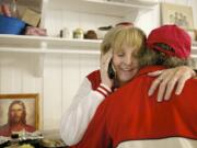 Michele Kruchoski embraces a Martha&#039;s Pantry client on a typical day in 2013. Kruchoski died overnight Wednesday but not before getting to speak to U.S. Sen. Patty Murray at the pantry earlier that day.