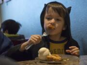 Thomas Gallegos, 6, of Vancouver eats a piece of baked French toast at Ice Cream Renaissance on Saturday for Eat Ice Cream for Breakfast Day. Thomas visited the store with his parents, Mike and Sarah Gallegos, and two brothers, Patrick and Anthony.