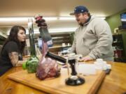 New Vansterdam retail marijuana shop assistant Jacy Reichlin helps customer Matt Ellis on Monday in Vancouver. The Vancouver City Council on Monday voted to increase the number of retail pot shops in the city from six to nine.