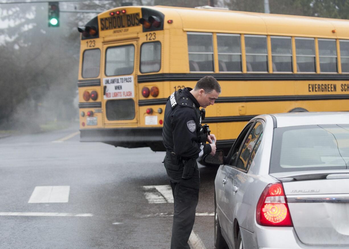 Deputy Sheriff Todd Young issues a citation to a woman who was speeding in a school zone near Covington Middle School on Monday.  The woman had just come from dropping off her child at school and told Young she was late for work.