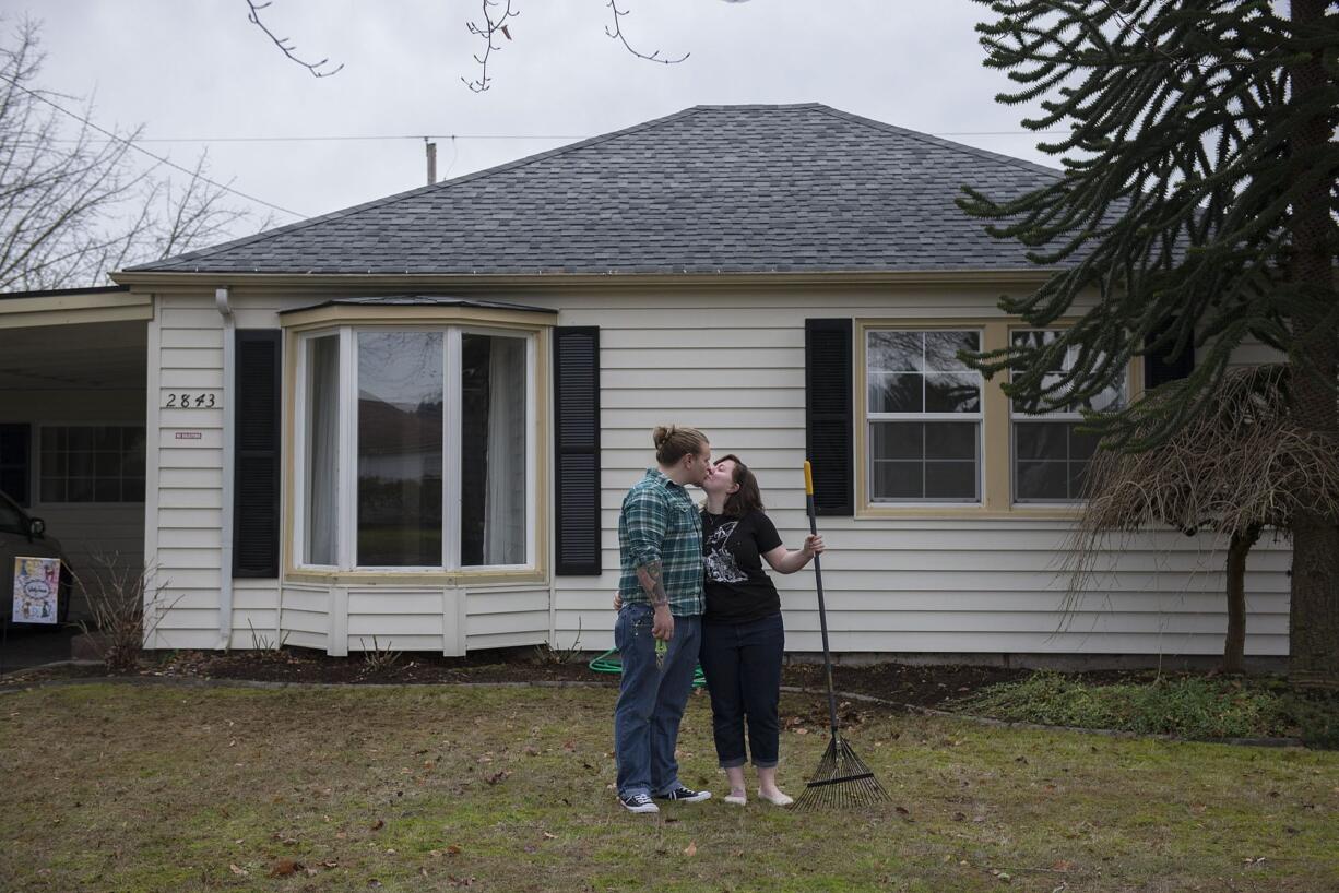 Nick and Nichole Ault share a sweet moment as they take a break from yard work Friday morning, Feb. 5, 2016 in Longview.