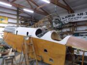 Jack Roy, with Century Aviation in East Wenatchee, works on the pilot&#039;s controls in the DH-4 Liberty that will go on display this summer at Pearson Air Museum.