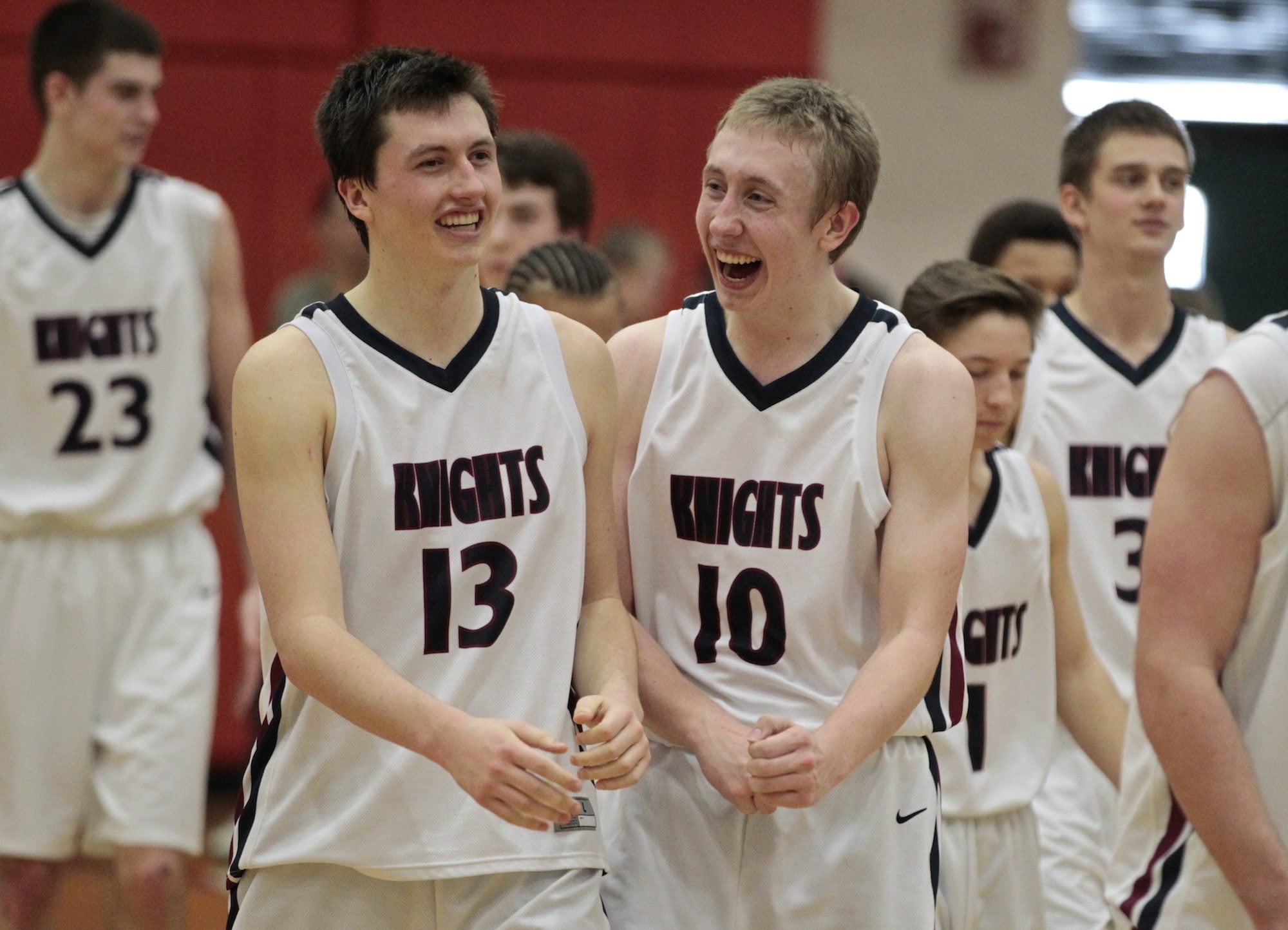 King's Way Christian's Joe Mills (13) and Skyler Freeman (11) celebrate the 52-31 Class 1A state playoff win over Cascade Christian at Battle Ground High School.