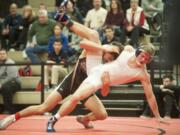 James Rogers of Battle Ground High School (L) spars with Sean Van Earwage (R) of Todd Beamer High School in the 145-pound weight class at the 4A Regional Wrestling Tournament in Camas on Saturday February 13, 2016.