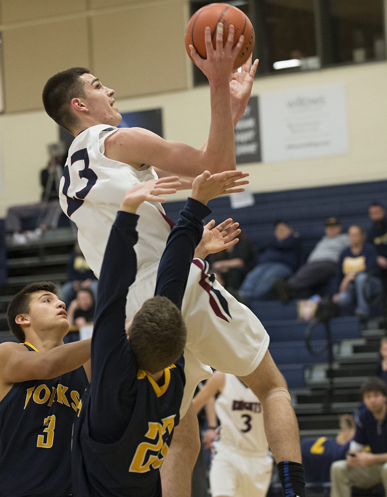 King's Ways Kienan Walter (23) glides past Forks defenders Keishaun Ramsey (3) and Cort Prose, bottom, in the second quarter Friday night, Feb. 12, 2016 at King's Way gym.