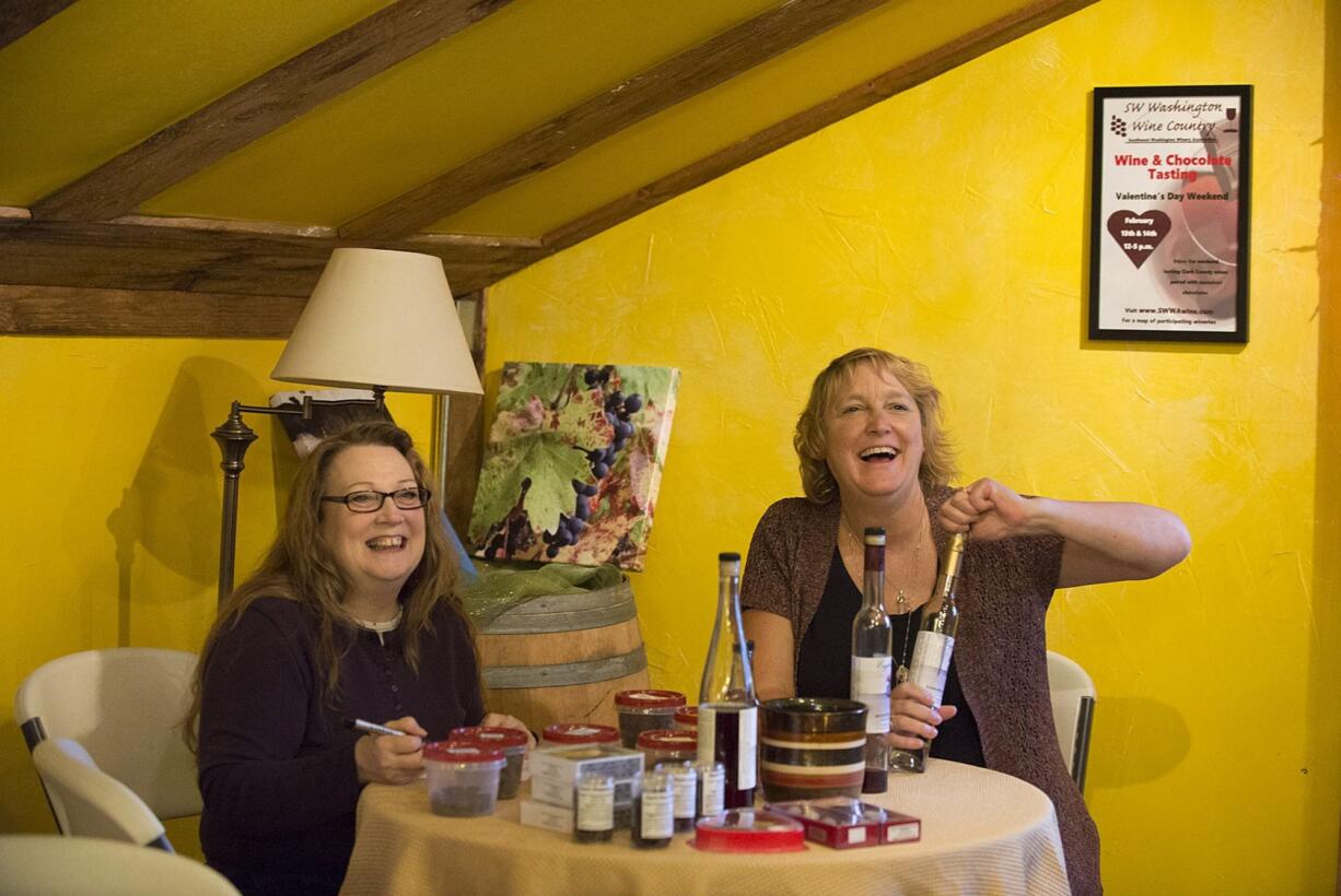 Peggy Moore of Peggy&#039;s Handmade Chocolates, left, joins English Estate Winery tasting room manager Andee Mowrey as they pair chocolates with wines earlier this month at the tasting room.