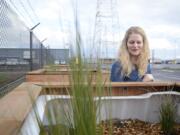 Port of Vancouver Environmental Program Manager Mary Mattix looks into a Grattix, an inexpensive and eco-friendly filtration she co-created to address stormwater issues at the Port.