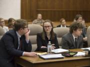 Camas High School students Bracy Ratcliff, 17, from left, Baylee Allen, 18, and Alex McOmie, 17, consult at the defense counsel table during Clark County&#039;s two-day district mock trial tournament Thursday at the Clark County Courthouse.