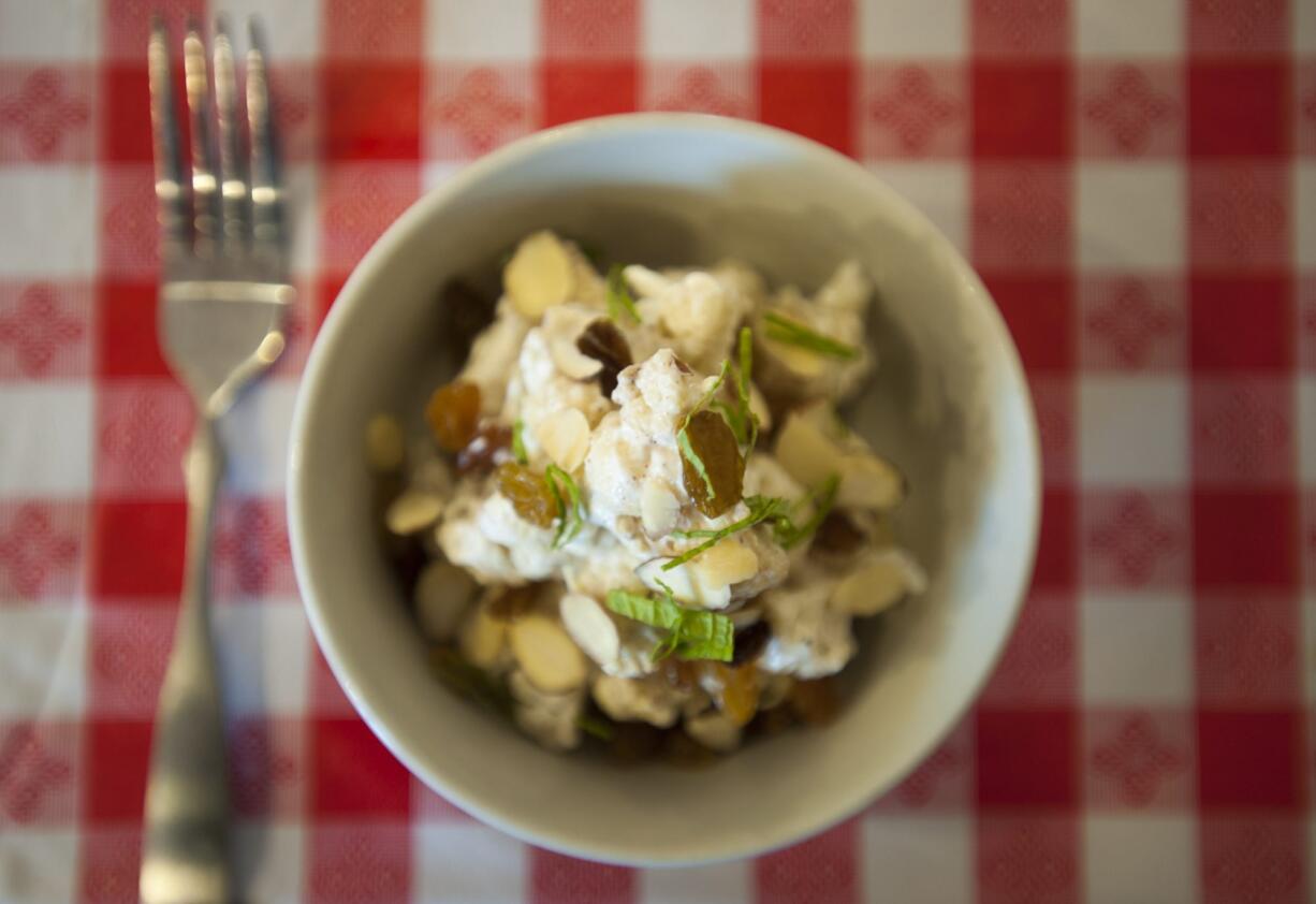 Roasted Cauliflower, prepared with golden raisin, almonds, allspice, yogurt and olive oil, is served at the  Commonwealth Cafe on Columbia Street in Vancouver.