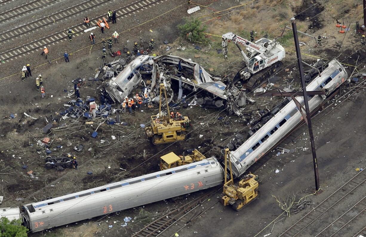 Emergency personnel work at the scene of a Tuesday night derailment in Philadelphia of an Amtrak train headed to New York. Federal investigators are expected to release interview transcripts, locomotive data and other evidence Monday that could help clear up the mystery of why the train streaked into a sharp curve at double the speed limit.