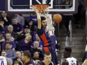 Arizona's Mark Tollefsen, top, dunks against Washington during the first half of an NCAA college basketball game Saturday, Feb. 6, 2016, in Seattle.