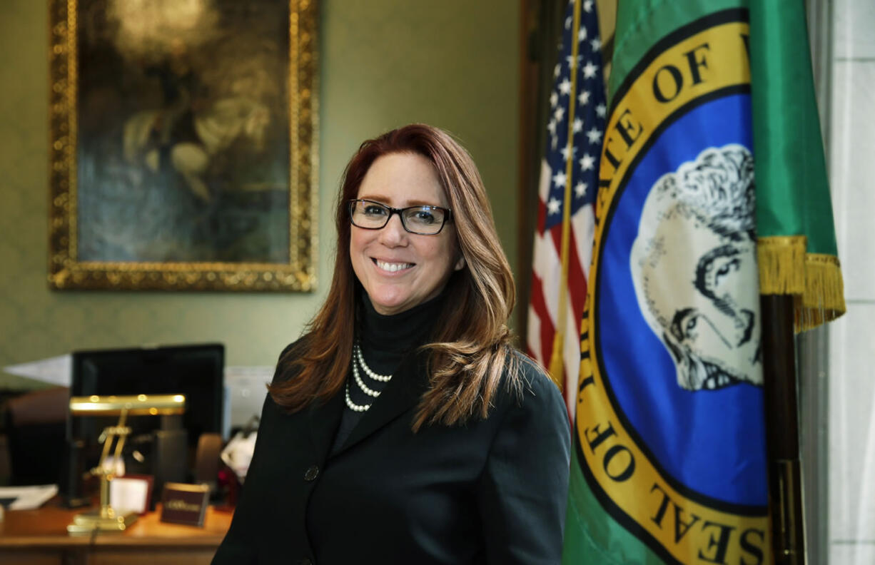 In this photo taken Feb. 1, 2016, Washington Secretary of State Kim Wyman poses for a photo in her office in Olympia, Wash. Months after Washington state saw record low voter turnout, Wyman and several lawmakers say they want to help increase voter engagement with automatic voter registration for some Washingtonians. (AP Photo/Ted S.