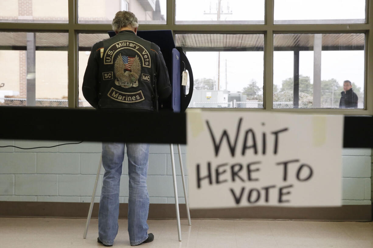 A South Carolina voter cast his ballot to vote in the Republican presidential primary Saturday, Feb. 20, 2016, in Lexington, S.C.