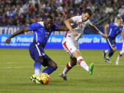 United States&#039; Jozy Altidore, left, and Canada&#039;s Steven Vitoria vie for the ball during the first half Friday at Carson, Calif. The U.S. won the friendly, 1-0. (Mark J.