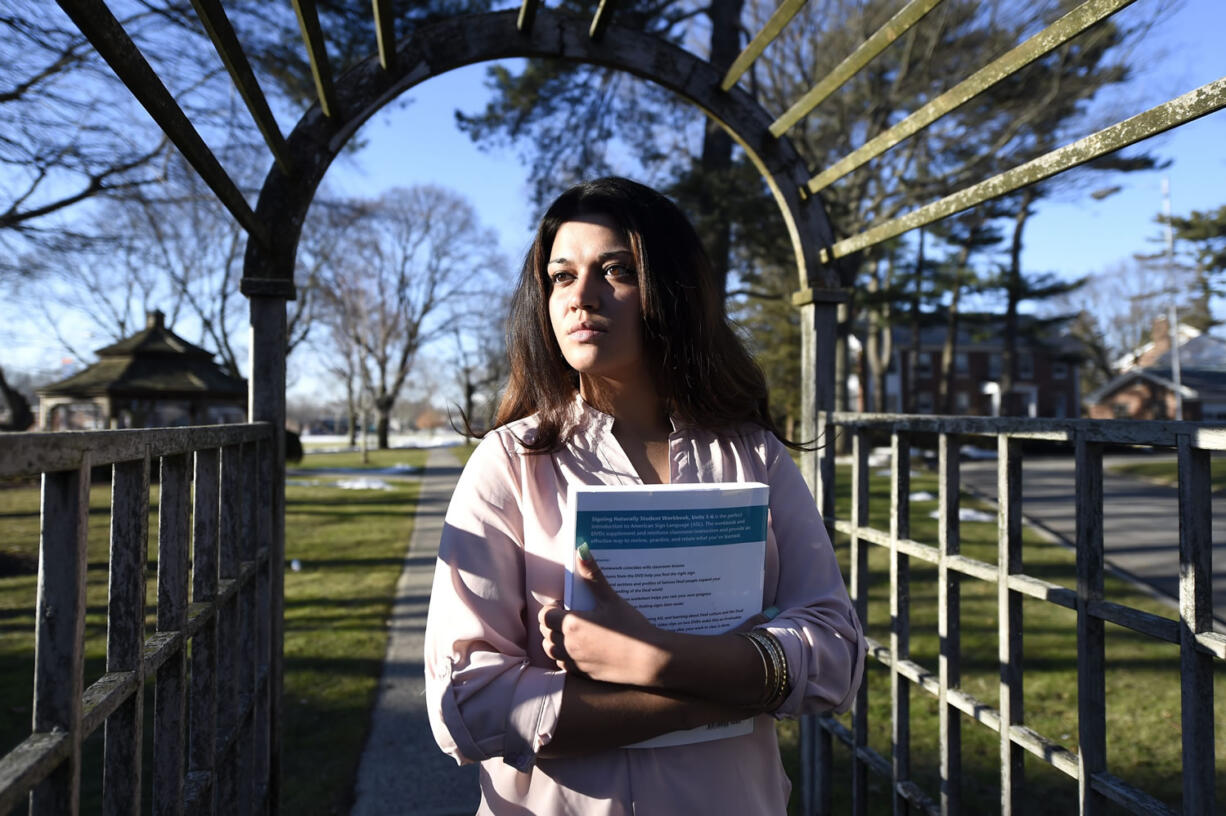 Naila Amin, 26, holds a book from one of the classes she is taking at Nassau Community College in Garden City, N.Y. Amin, who was forced into marriage at the age of 15 to a 28-year-old cousin in Pakistan who beat and mistreated her, aspires to become a social worker and open a group home for girls trying to avoid or recover from forced marriages.