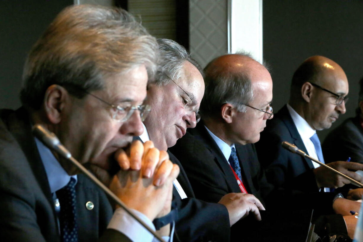 Ministers of Foreign Affairs of Italy, Paolo Gentiloni, left, Greek Nikolaos Kotzias, second left, and France&#039;s minister of state for European affairs Harlem Desir, right, are seen during the third Mediterranean group Ministerial meeting in southern port city of Limassol in the Island of Cyprus, Friday, Feb. 26, 2016. Cyprus hosts the third meeting of foreign ministers from Spain, Portugal, Greece, Italy, Malta and France to discuss challenges faced by the European Union&#039;s southern flank, like migration flows and security concerns.