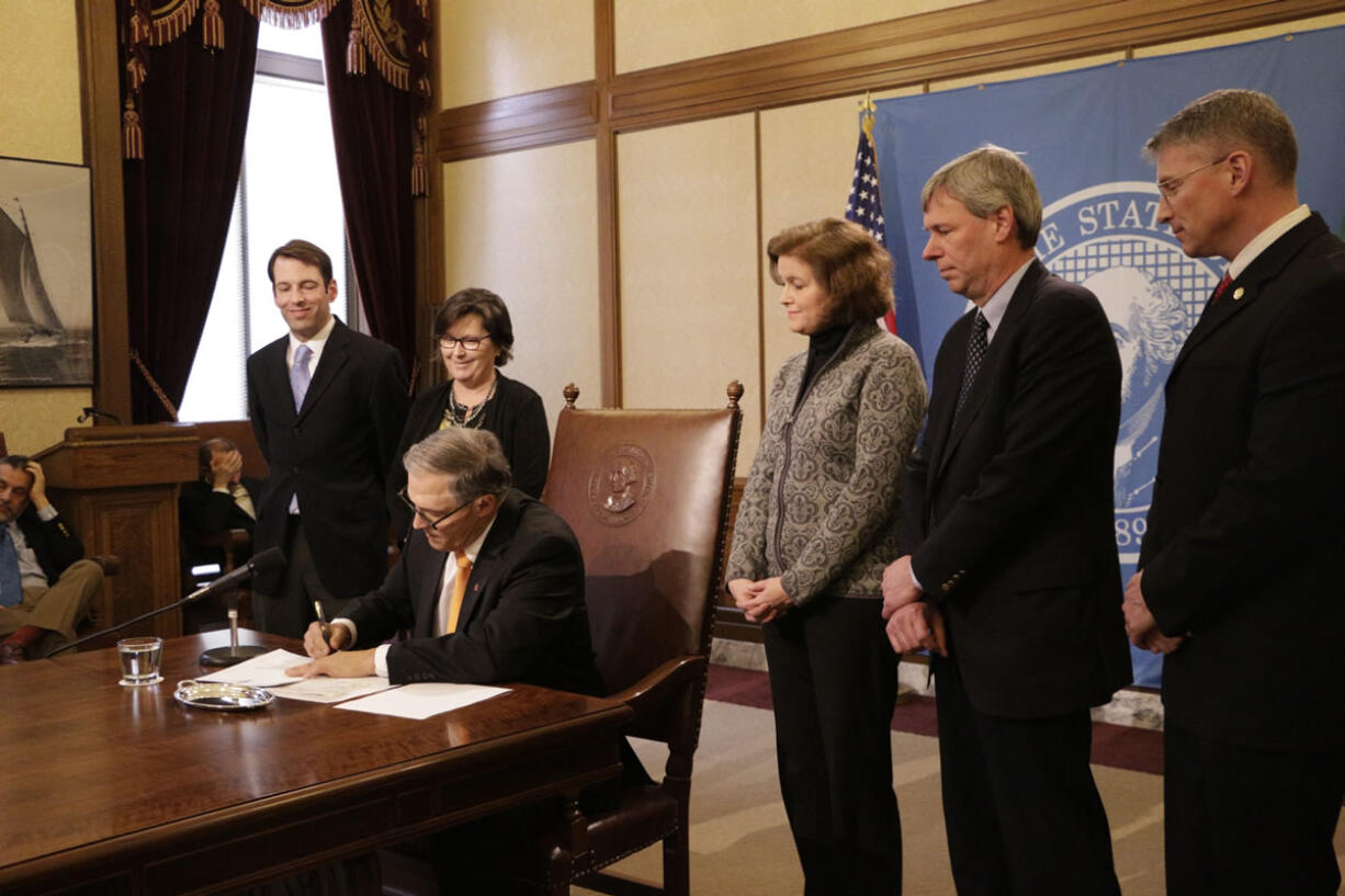 Joined by Democratic and Republican lawmakers, Gov. Jay Inslee on Monday signs a bill that sets out a plan for finishing the Legislature&#039;s work of reforming the way the state of Washington pays for K-12 education, in Olympia. It is designed to answer the Supreme Court&#039;s ruling in 2012 that Washington&#039;s school funding was not adequate or uniform.