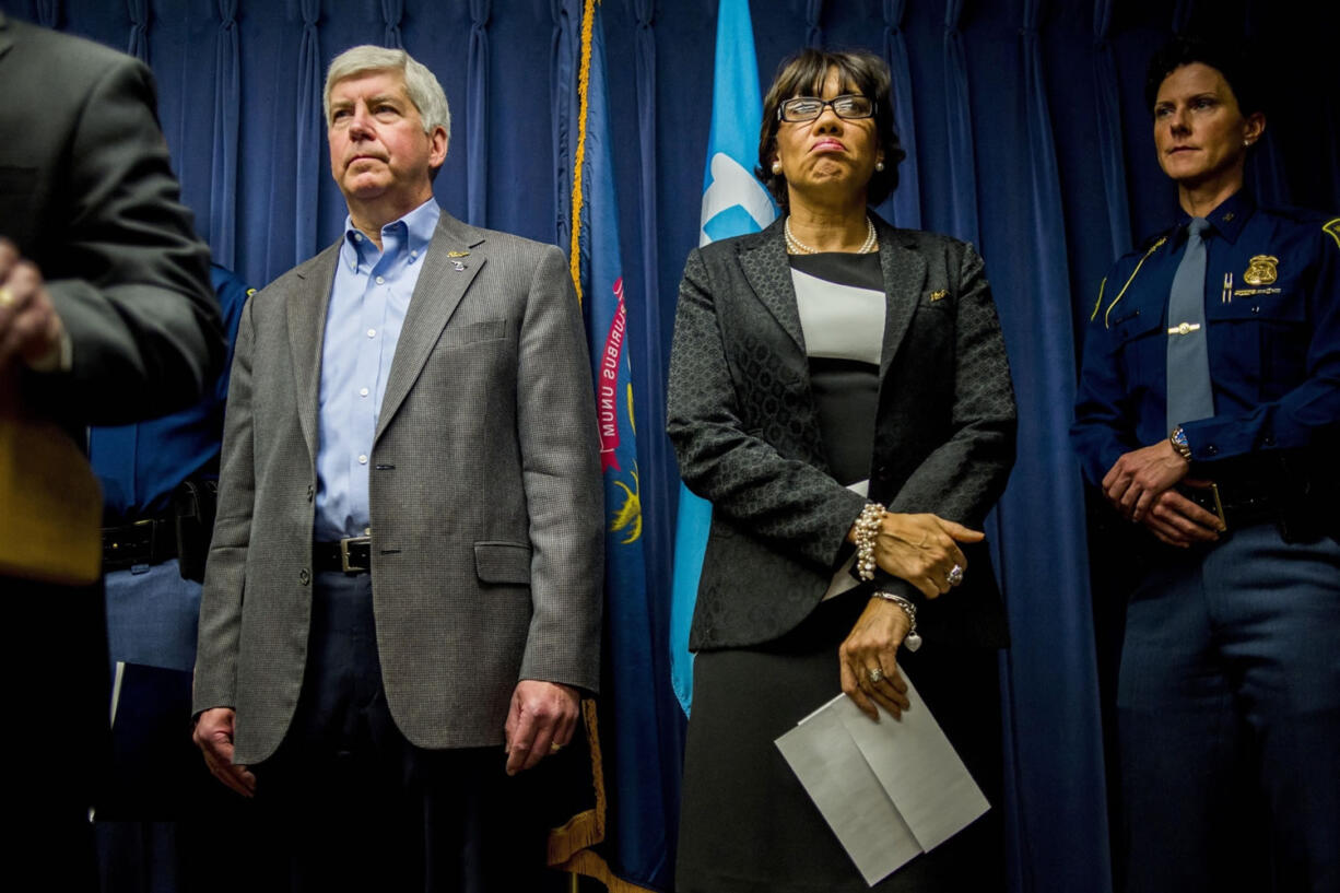 Michigan Gov. Rick Snyder, left, stands beside Flint Mayor Karen Weaver as they prepare to field questions about the city&#039;s water crisis during a press conference Jan. 27 in Flint, Mich.