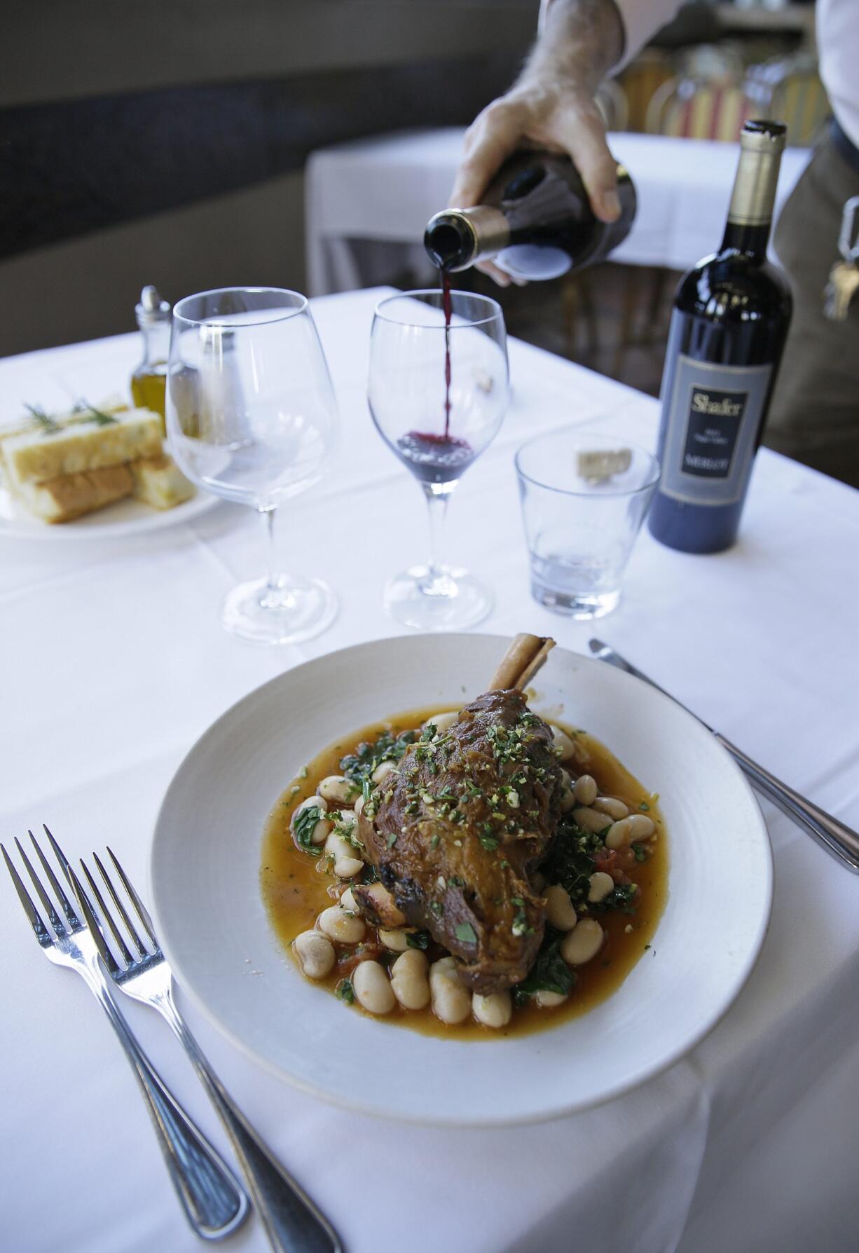 A lamb shank dish with a Tuscan bean ragu, natural jus and gremolata is paired with Shafer merlot and Relentless wines at the Bistro Don Giovanni restaurant in Napa, Calif. There&#039;s some debate over whether &quot;red with beef&quot; and &quot;white with chicken and pork&quot; is an absolute or a rule made to be broken.