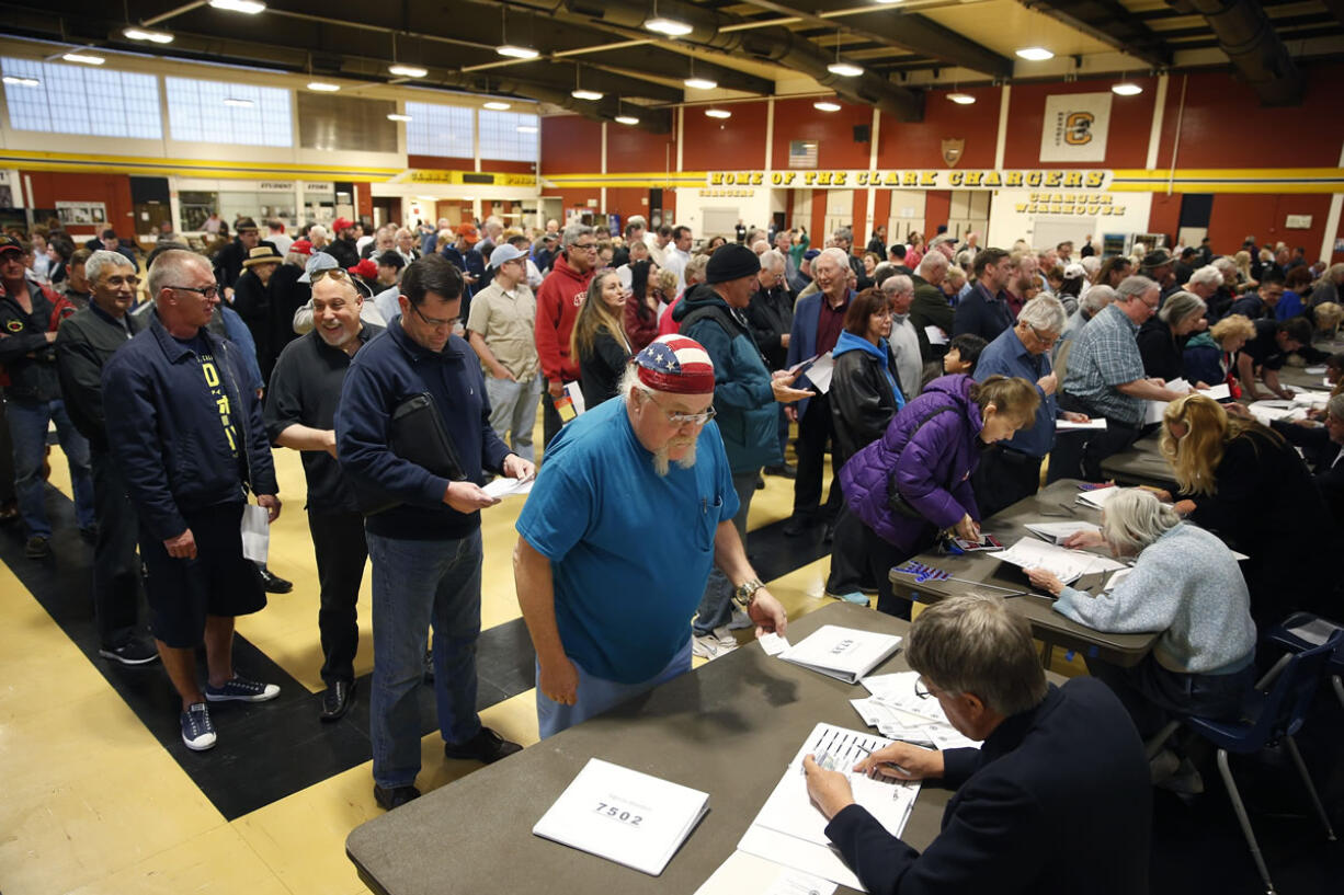 Crowds of people line up Tuesday to get a ballot at a Republican caucus site in Las Vegas.