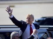 Republican presidential candidate Donald Trump waves as he leaves a rally Saturday in Bentonville, Ark.