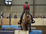 Kylie Vroman and Lenny, of Battle Ground, compete in the Craig Cameron Extreme Cowboy Race in 2013.