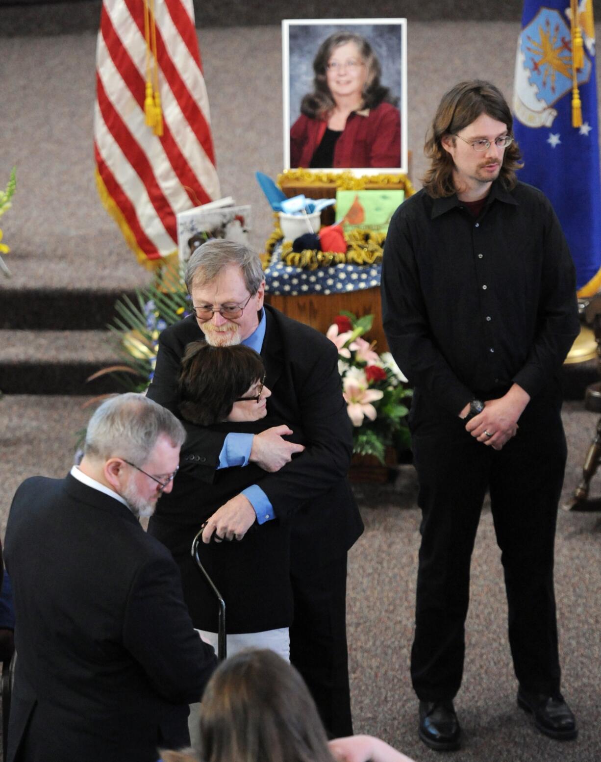 Christopher Nye, center, husband of shooting victim Mary L. Nye, greets family and friends Saturday along with his son, Bart (Gwen) Nye, right, during a memorial service in Bridgman, Mich.