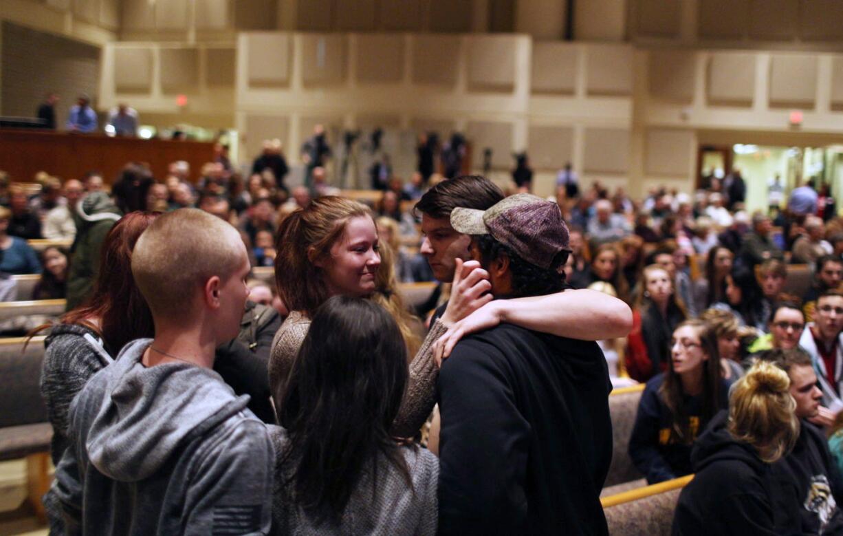 Members of the community pray before the start of the Kalamazoo Community Prayer Service at Centerpoint Church on in Kalamazoo, Mich., on Sunday.(Andraya Croft/Detroit Free Press via AP)