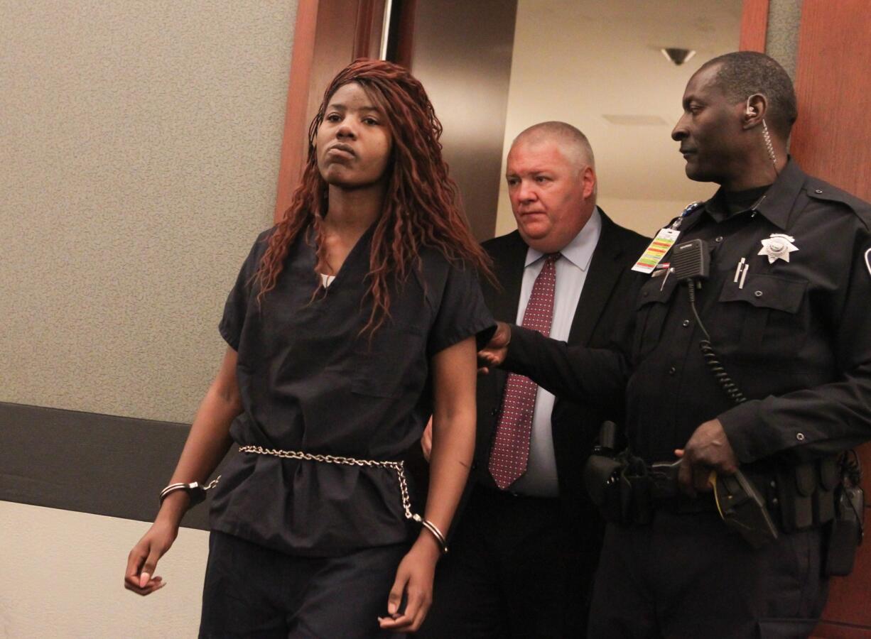 Lakeisha Nicole Holloway enters district court in December with one of her public defenders, Scott Coffee, for her arraignment in Las Vegas.