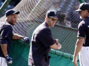 The Seattle Mariners' hitting coach, Edgar Martinez, center, stands with assistant hitting coach Andy Van Slyke (43) and Robinson Cano outside the batting cage in this June 2015 photo. Robinson Cano didn't spend much time dwelling on the searing comments a former assistant coach made about him. He was home in the Dominican Republic, recovering from surgery to repair a sports hernia that he played through for the final two months of last season. The Seattle Mariners' six-time All-Star second baseman addressed former assistant hitting coach Andy Van Slyke's offseason criticism of him on Thursday, Feb. 25, 2016, before the first full-squad workout of spring training.