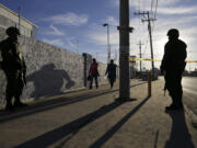 Soldiers stand guard as people arrive to get a glimpse of Pope Francis along the pontiff&#039;s planned route in Cuidad Juarez, Mexico, on Wednesday.