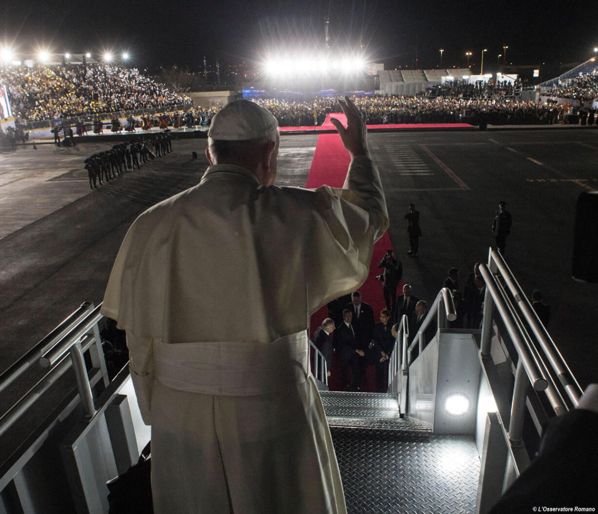 Pope Francis waves as he board his flight to Rome during the farewell ceremony at Ciudad Juarez, Mexico.