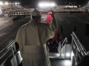 Pope Francis waves as he board his flight to Rome during the farewell ceremony at Ciudad Juarez, Mexico.