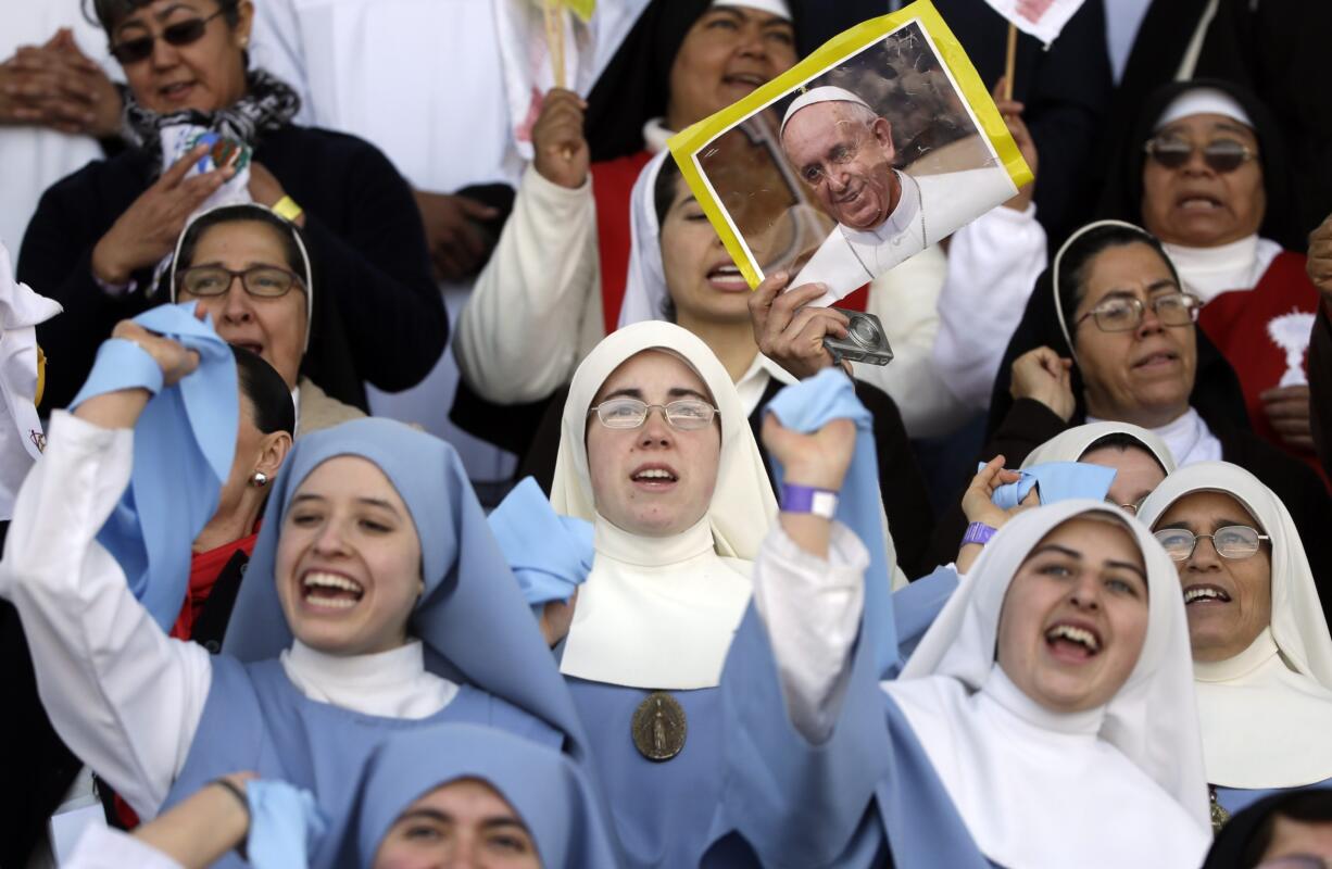 Nuns sing before the arrival of Pope Francis at Venustiano Carranza stadium in Morelia, Mexico, on Tuesday. Francis arrived in the heart of Mexico&#039;s drug-trafficking country to offer words of encouragement to priests trying to minister to a people tormented by the violence and gang warfare of the drug trade.